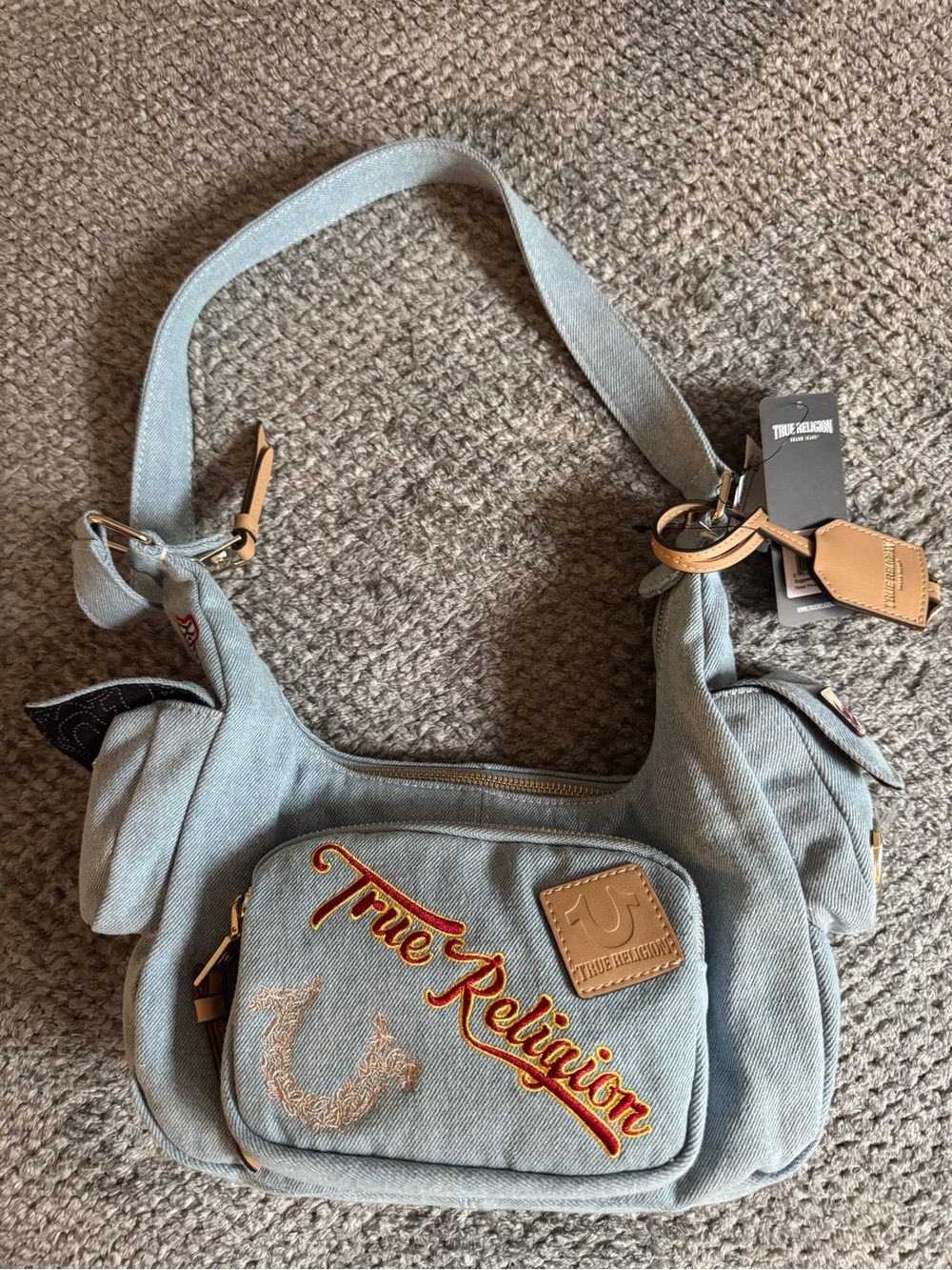 True Religion Light Denim Shoulder Bag with Red Script and Tan Accents